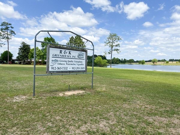 Business sign with pond in background