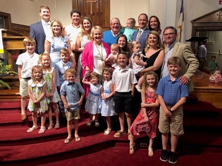 Coggins family posing together inside a church
