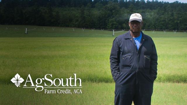 Jim McClain stands in his field