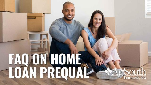 Couple sitting on the floor by boxes