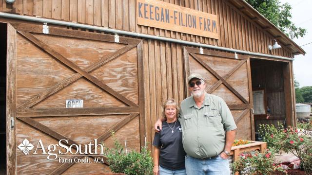 Couple in front of barn