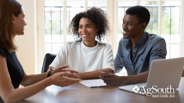 Couple speaking with loan officer