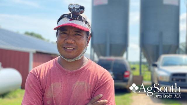 Poultry Farmer Z Kam In Front of His Chicken Houses