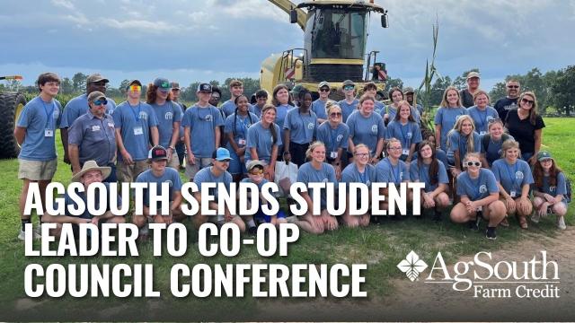 Group photo of kids with tractor in background