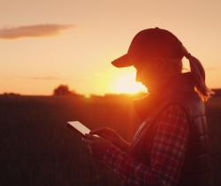 female farmer looking at tablet agsouth