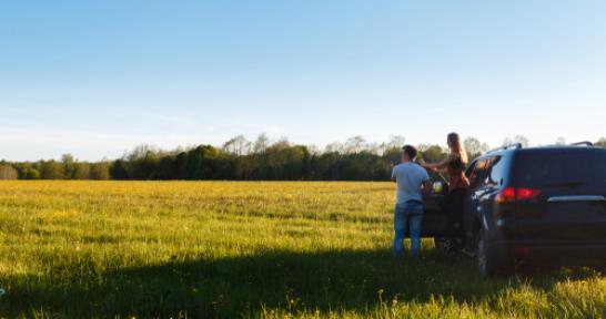 couple in car looking at land